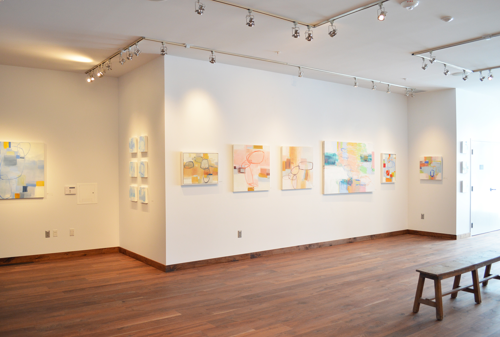 Wall of pink paintings, gallery view