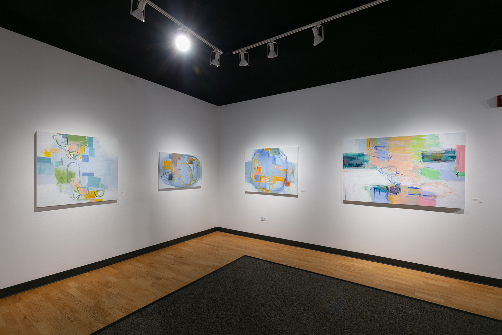 Julia Rymer's paintings installed in a gallery space.